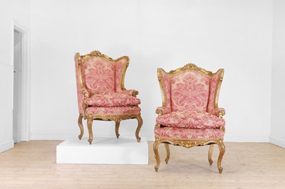 Lot 224 - A pair of carved giltwood wing armchairs
