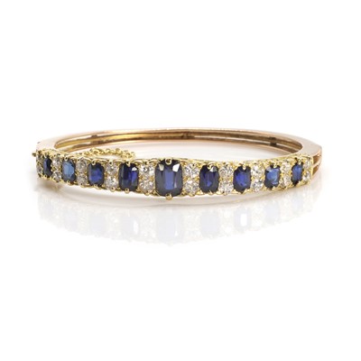 Lot 23 - A Victorian sapphire and diamond hinged bangle