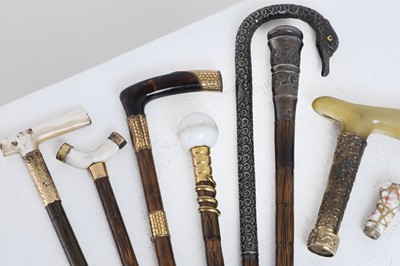 Lot 250 - A collection of Edwardian parasol and cane handles and mounts