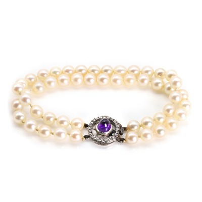 Lot 200 - A pearl bracelet with an amethyst and diamond clasp