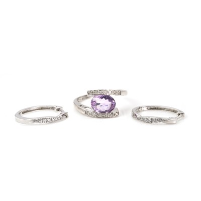 Lot 249 - A 9ct white gold amethyst and diamond ring and a pair of diamond earrings