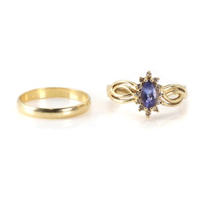Lot 263 - A tanzanite and diamond ring and a gold wedding ring
