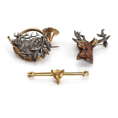 Lot 352 - A small group of gold, silver and base metal brooches