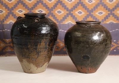 Lot 667 - A black glazed stoneware water jar