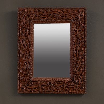 Lot 678 - An Indian carved hardwood wall mirror