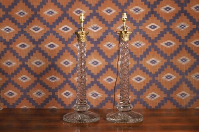 Lot 565 - A pair of facet cut glass table lamps