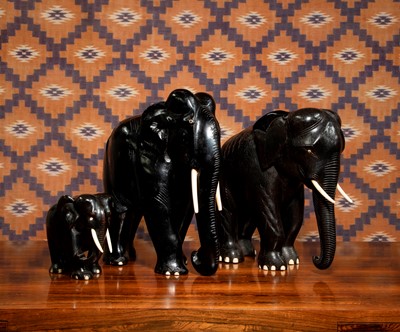 Lot 748 - A group of ebonised carved wood elephants