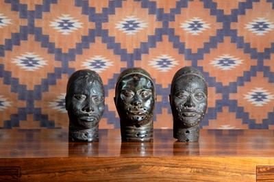 Lot 660 - A group of three Benin bronze heads.