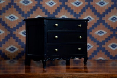 Lot 591 - A French provincial ebonised miniature commode