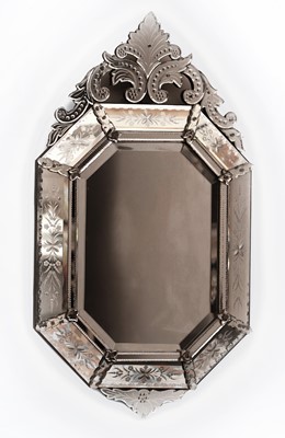 Lot 616 - A Venetian style cushion framed wall mirror