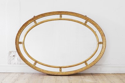 Lot 299 - A George III-style carved giltwood and gesso oval mirror