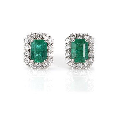 Lot 153 - A pair of white gold emerald and diamond stud earrings