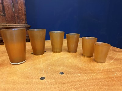 Lot 544 - A leather cased set of six horn stirrup cups