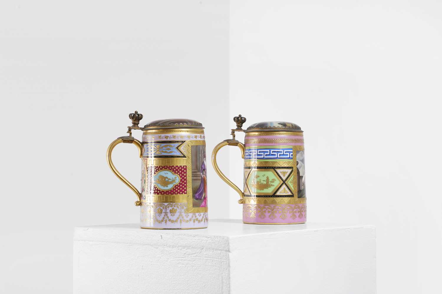 Lot 423 - A pair of Vienna porcelain and gilt-metal-mounted tankards