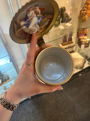 Lot 423 - A pair of Vienna porcelain and gilt-metal-mounted tankards