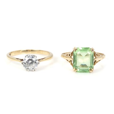Lot 254 - A zircon single stone ring and a green paste ring