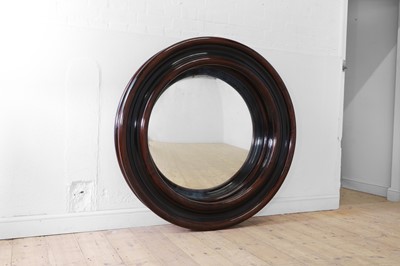 Lot 144 - A large lacquered wooden convex mirror by Charles Edwards