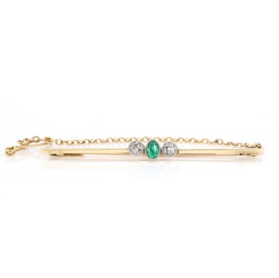 Lot 65 - An emerald and diamond three stone bar brooch