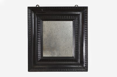 Lot 188 - A baroque ebonised fruitwood mirror