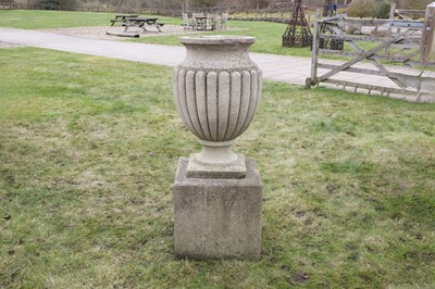 Lot 720 - A neoclassical carved composition stone urn