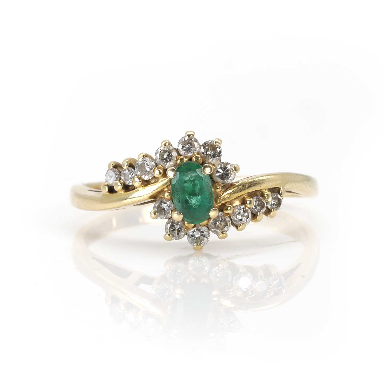 Lot 90 - An 18ct gold emerald and diamond cluster ring