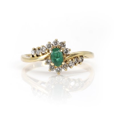 Lot 90 - An 18ct gold emerald and diamond cluster ring