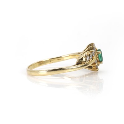 Lot 90 - An 18ct gold emerald and diamond cluster ring