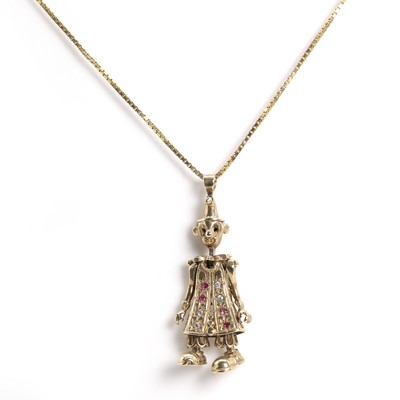 Lot 127 - A gold articulated ruby and diamond clown pendant