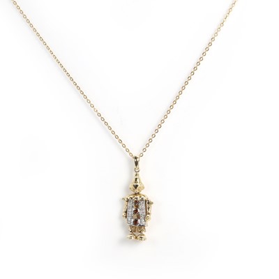 Lot 128 - A 9ct gold garnet and diamond articulated clown pendant