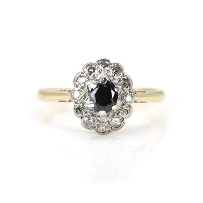 Lot 164 - A diamond and sapphire cluster ring