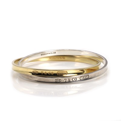 Lot 215 - An 18ct gold and silver Interlocking Circles bangle, by Tiffany & Co.