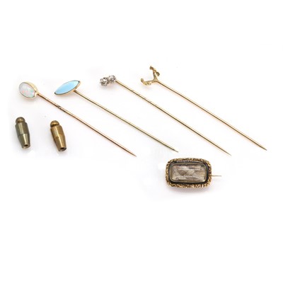 Lot 305 - A small collection of stick pins and a mourning brooch
