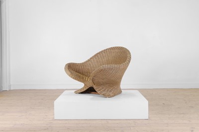 Lot 405 - A shaped wicker armchair