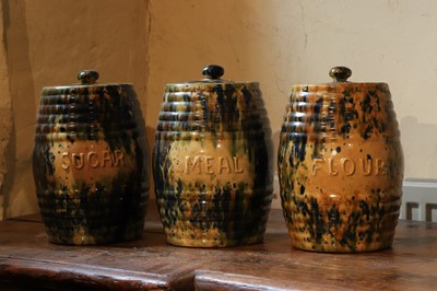 Lot 516 - A set of three glazed earthenware storage jars and covers