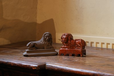 Lot 515 - Two models of recumbent lions