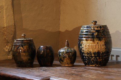 Lot 518 - A collection of glazed earthenware jars and covers