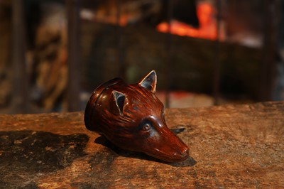 Lot 519 - A treacle-glazed earthenware stirrup cup