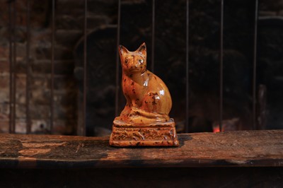 Lot 520 - A slip-glazed terracotta figure of a seated fox