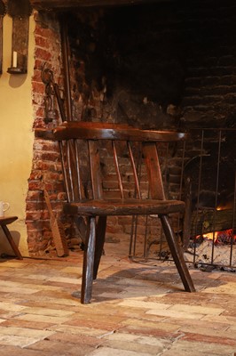 Lot 532 - A primitive oak, ash and elm yoke-back Windsor armchair