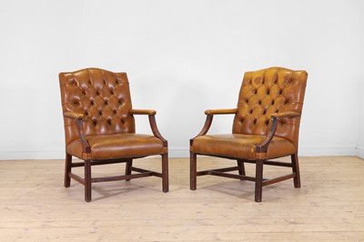 Lot 610 - A pair of George III-style buttoned leather and stained beech Gainsborough library armchairs