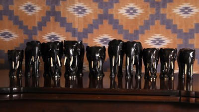 Lot 683 - A series of ten ebony elephants of various sizes