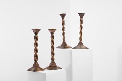 Lot 36 - A set of four turned oak candlesticks
