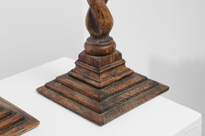 Lot 36 - A set of four turned oak candlesticks