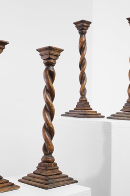 Lot 36 - A set of four turned oak candlesticks