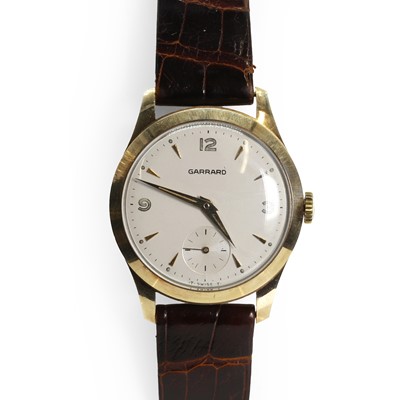 Lot 428 - A gentlemen's 9ct gold mechanical strap watch, by Garrard