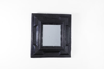 Lot 199 - A baroque ebonised wooden mirror