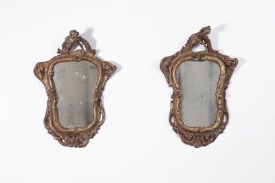 Lot 36 - A pair of small rococo giltwood mirrors