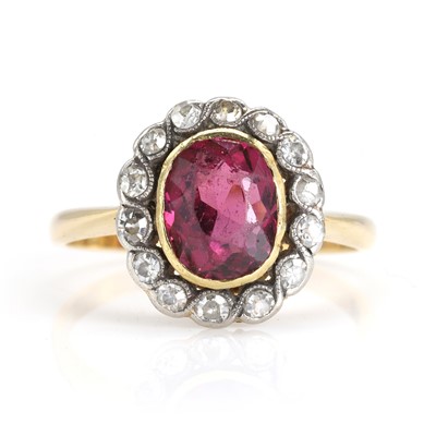 Lot 101 - A rhodolite garnet and diamond cluster ring