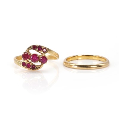 Lot 207 - A ruby crossover ring and a wedding ring