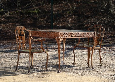 Lot 687 - A cast iron garden table and two chairs